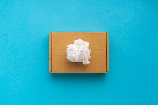 Cardboard box with cotton paper on top on a blue background Concept recycle garbage to the blue container