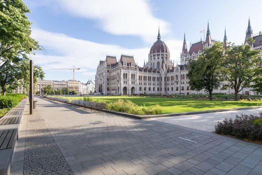 Hungarian parliament building and park from behind on a sunny day in summer season, angled view in Budapest, Hungary.
