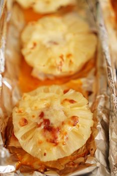 Chicken fillet with pineapples on a baking sheet. Cooking chicken with pineapple in the oven on foil