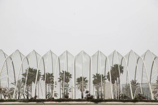 Valencia, Spain - 04, 05, 2018: Exterior view of L'umbracle with its characteristic structure and trees inside, in the City of Arts and Sciences