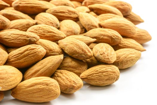 Pile of almonds on a white background in close-up.