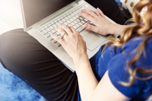 young caucasian woman typing on laptop keyboard. Working from home. Smart working concept