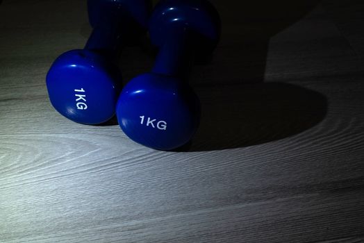 Blue dumbbells on the floor
