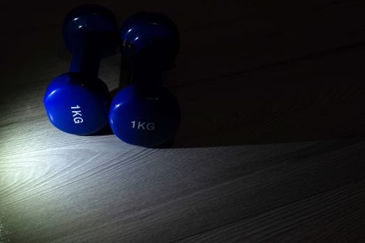 Blue dumbbells on the floor