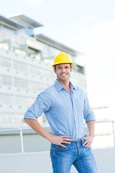 Portrait of handsome architect with hands on hips outdoors