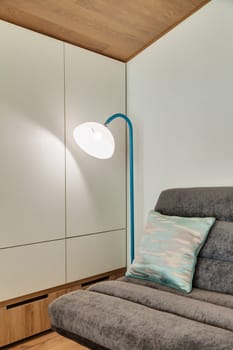 Fragment of a modern room with a sofa and floor lamp