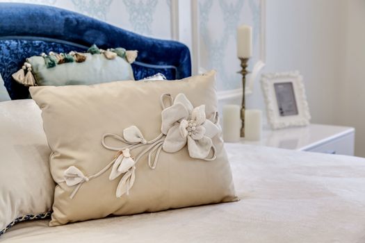 Headboard With decorative pillows and a candelabra over the bed