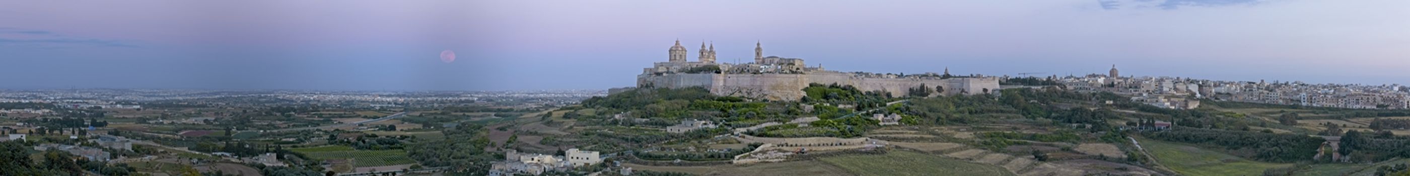 A super Moon rises over a panoramic view of the medieval city of Mdina and its surrounding countryside in Malta
