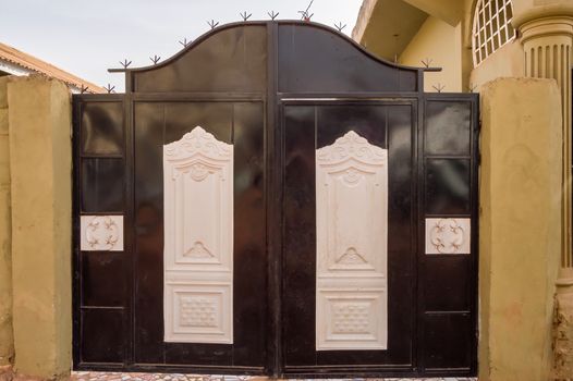 Black metal door of a residential house in Bijilo in The Gambia, West Africa
