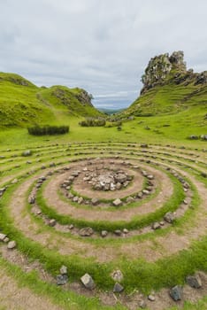 Landscape of a circle of stones and hills with green grass, Fairy Glen, Scotland