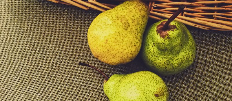Organic pears on rustic linen background, fruits farming and agriculture