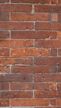 The close up of vintage red brick block wall background pattern.