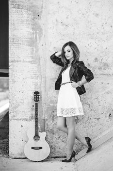 musician young girl with red hair with an acoustic guitar