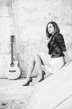 musician young girl with red hair with an acoustic guitar