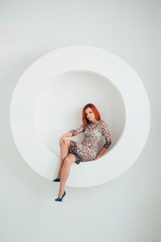 red-haired model girl with blue eyes on a white circle background