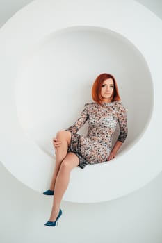 red-haired model girl with blue eyes on a white circle background