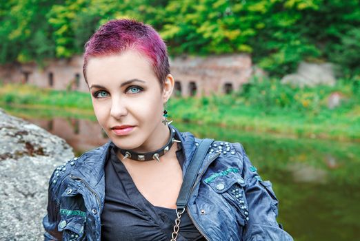 portrait of young beautiful punk girl with metal spiked collar