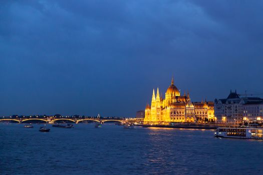 Panoramic view of Hungarian parliament with the river and at night