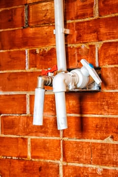 two white plastic taps in rustic bath closeup