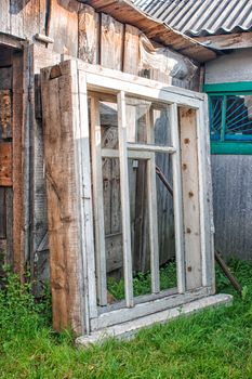 old wooden window in the yard on summer day