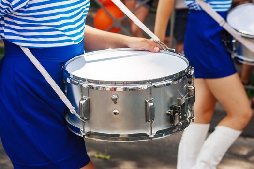 group of girls drummers. parade on a city street. body parts closeup