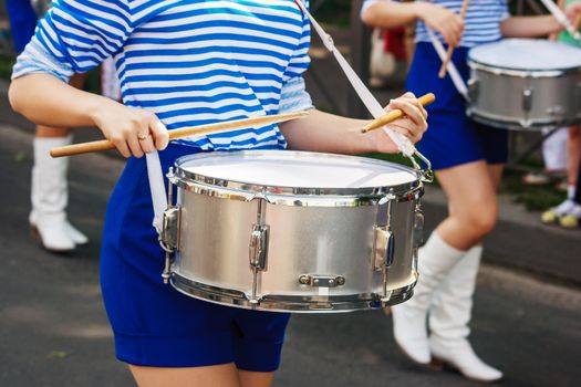 group of girls drummers. parade on a city street. body parts closeup