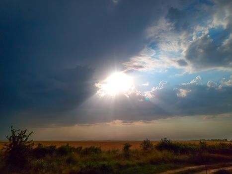 Beautiful sunset, sun rays through the clouds.