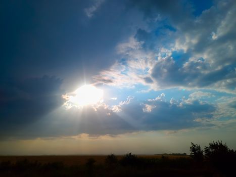 Beautiful sunset, sun rays through the clouds.