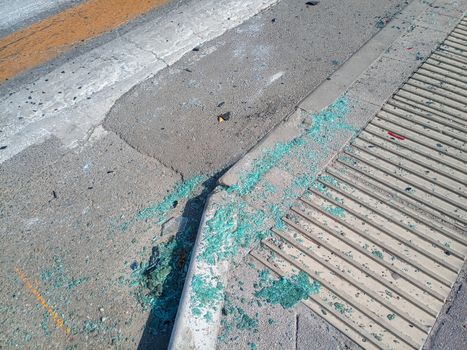 Pieces of car windows on the asphalt. The scene of a car accident on the road.