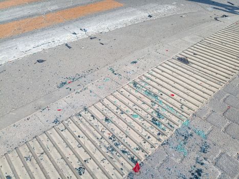 Pieces of car windows on the asphalt. The scene of a car accident on the road.