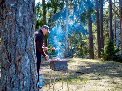 Red hot burning charcoal preparing for grilling, barbecue grill, BBQ. Forest on the background. Waiting for the placement of your food. Close up. vacation concept