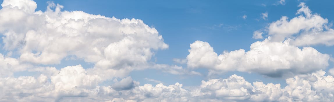 Panoramic white fluffy clouds in the blue sky, Fantastic soft white clouds against blue sky