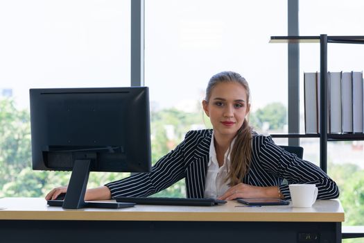 Teen staff poses confidently before starting their work in the morning. Morning work atmosphere in a modern office.