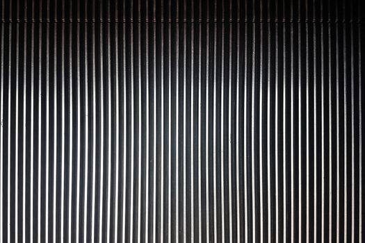 Textured background of striped pattern of a metal escalator in close-up