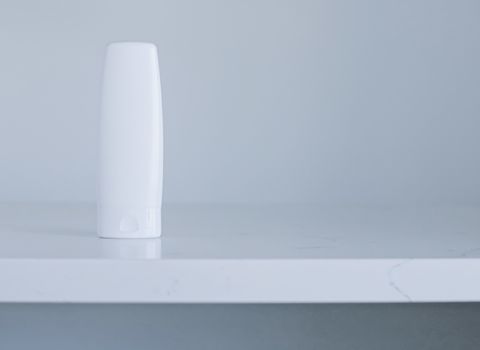Blank label cosmetic container bottle as product mockup on gray background, hygiene and healthcare