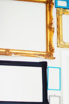 Empty art frames on gallery wall, decor and design details