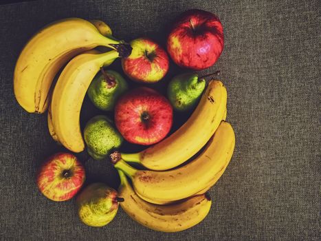 Organic apples, pears and bananas on rustic linen background, fruits farming and agriculture