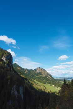 Beautiful nature of European Alps, landscape view of alpine mountains, lake and village on a sunny day, travel and destination scenery