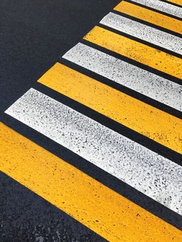 Pedestrian zebra crossing. Road markings on the asphalt. Painted signs on the roadway and pedestrian crosswalk.