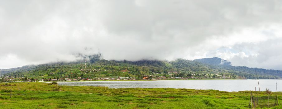 Panorama view on agricultural fields near Batur volcano, Kintamani. Winter rainy and cloudy season. Bali, Indonesia.