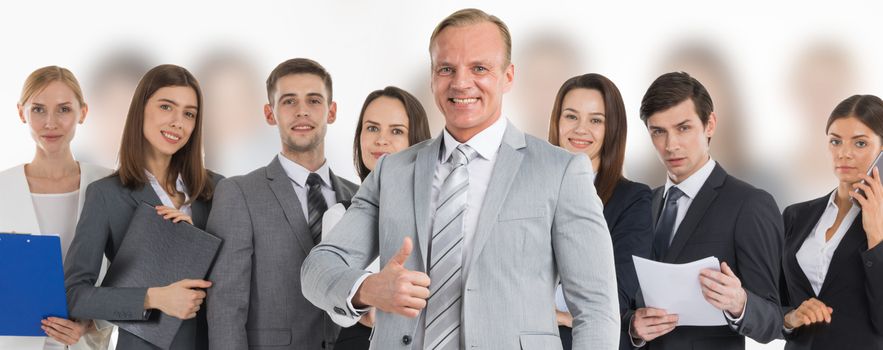 Business man hold hand with thumb up gesture, business man excited happy smile over group of businesspeople team background