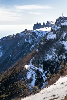 Panorama view from Ai-Petri mountain. Snow and iced pine trees on sunny winter day. Crimea, Black sea, Russia.