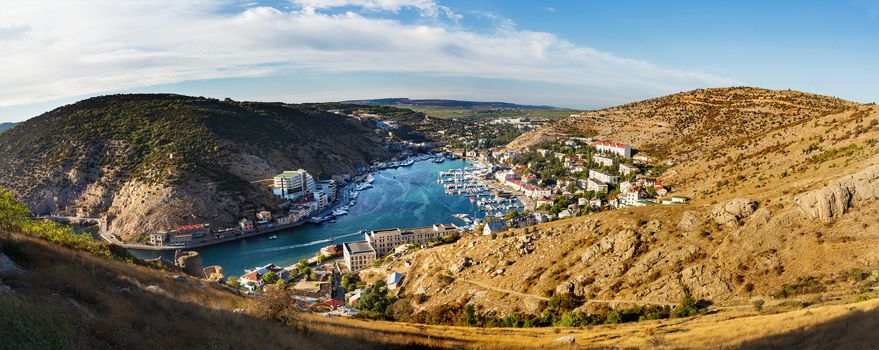 Panorama view of Balaclava from the ancient fortress Chembalo. Balaclava Bay with yachts in bright sunny day. Crimea, Rusiia.