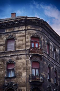 Beautiful old timeworn residential building in Budapest, Hungary, on a beautiful day with clear blue sky.