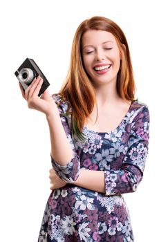 Beautiful smiling young girl with closed eyes, looking pleased and happy, holding an old camera, isolated on white background.