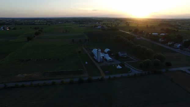 Aerial View of a Sunset on a Summer Day in Amish Countryside as Seen by a Drone