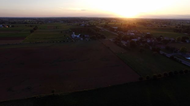 Aerial View of a Sunset on a Summer Day in Amish Countryside as Seen by a Drone