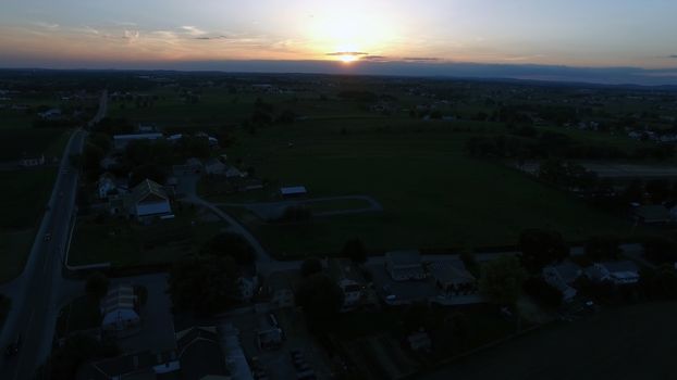 Aerial View of a Sunset on a Summer Day in Amish Countryside as Seen by a Drone