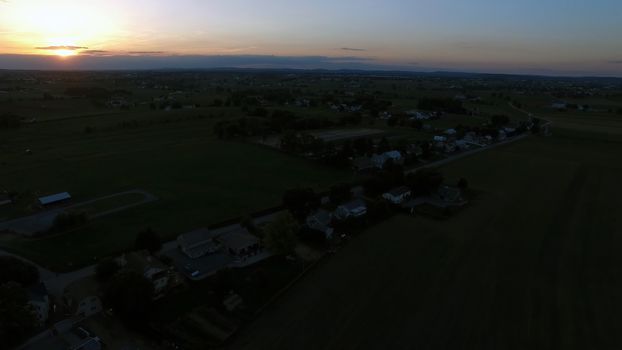 Aerial View of a Sunset on a Summer Day in Amish Countryside as Seen by a Drone