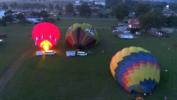 Lancaster, Pennsylvania, September 2018 - Aerial View of Sunrise with Hot air Balloons Taking Off with Glow as Seen by a Drone